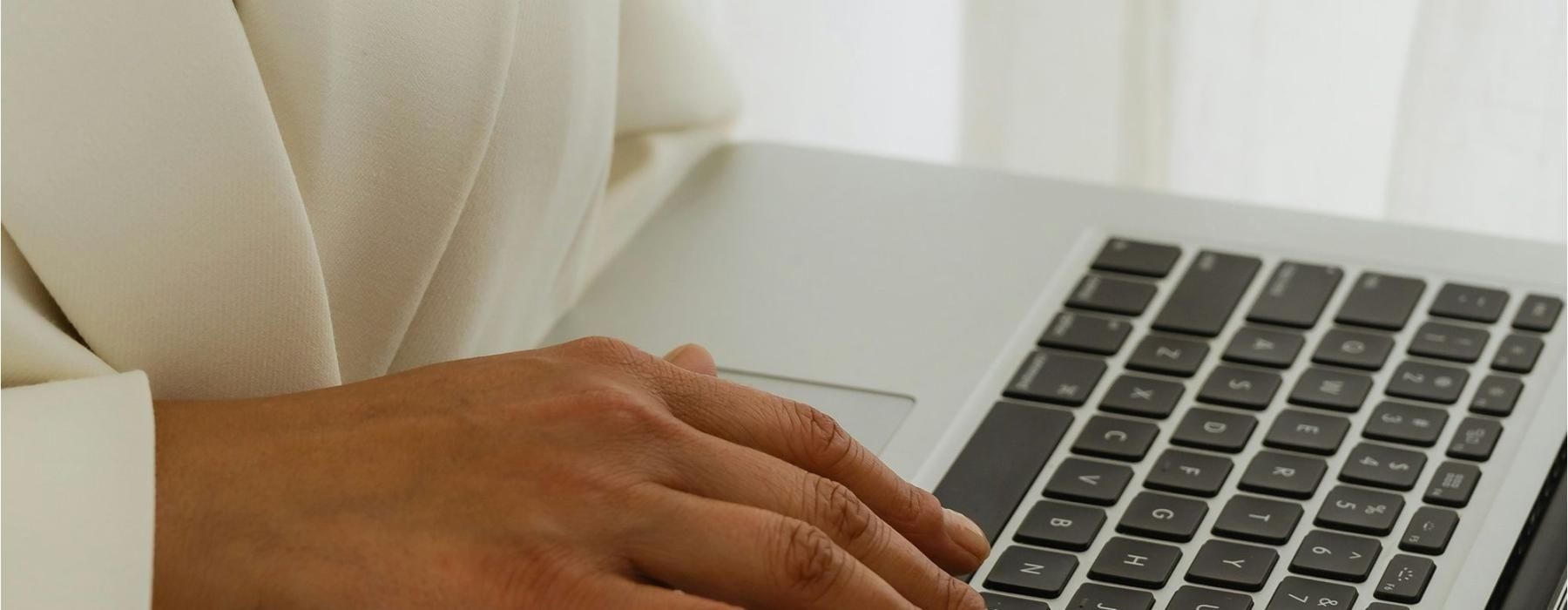 Resident using a laptop at The Rowan - apartments for rent in Oviedo, FL